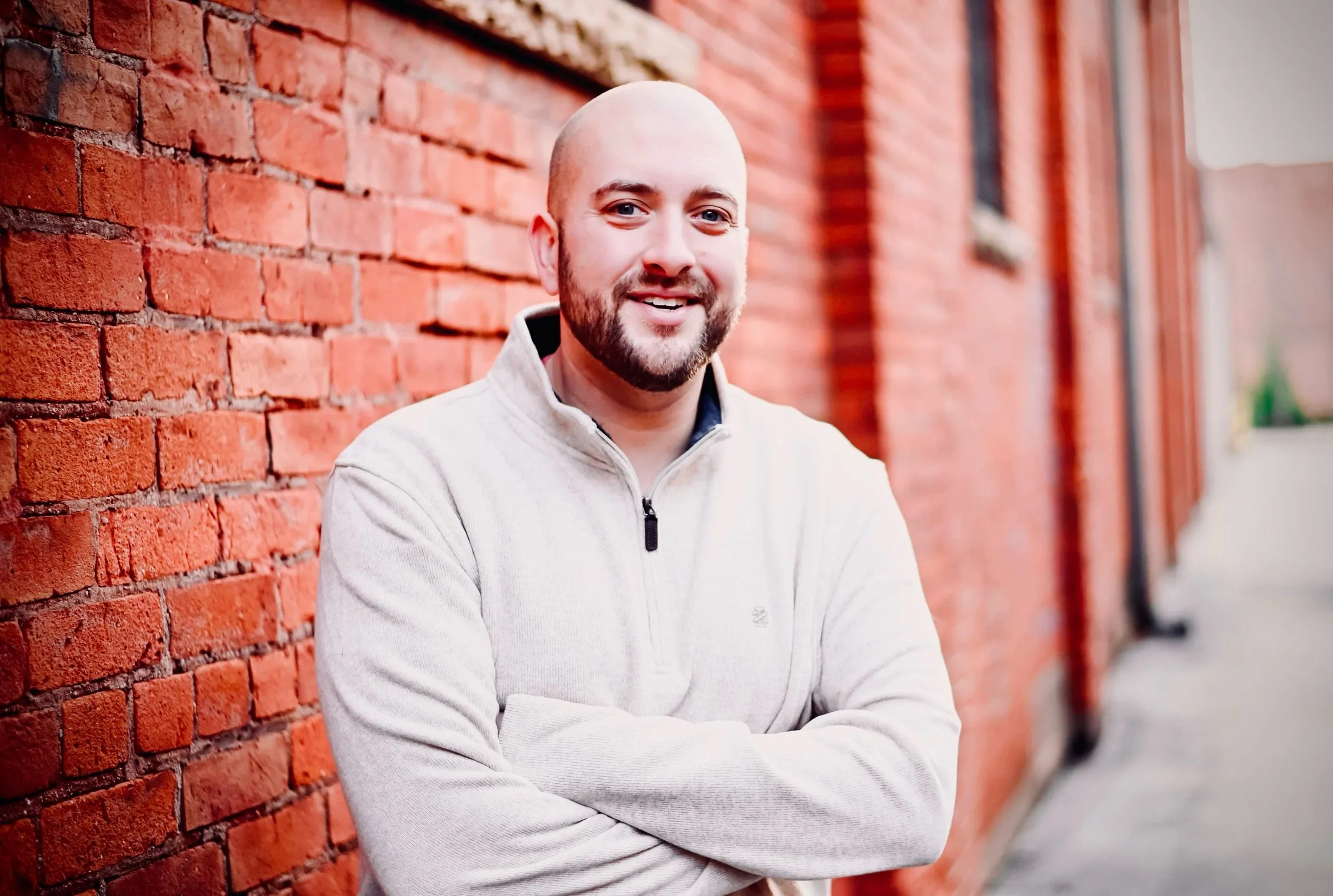 Tommy Renfro standing against a brick wall